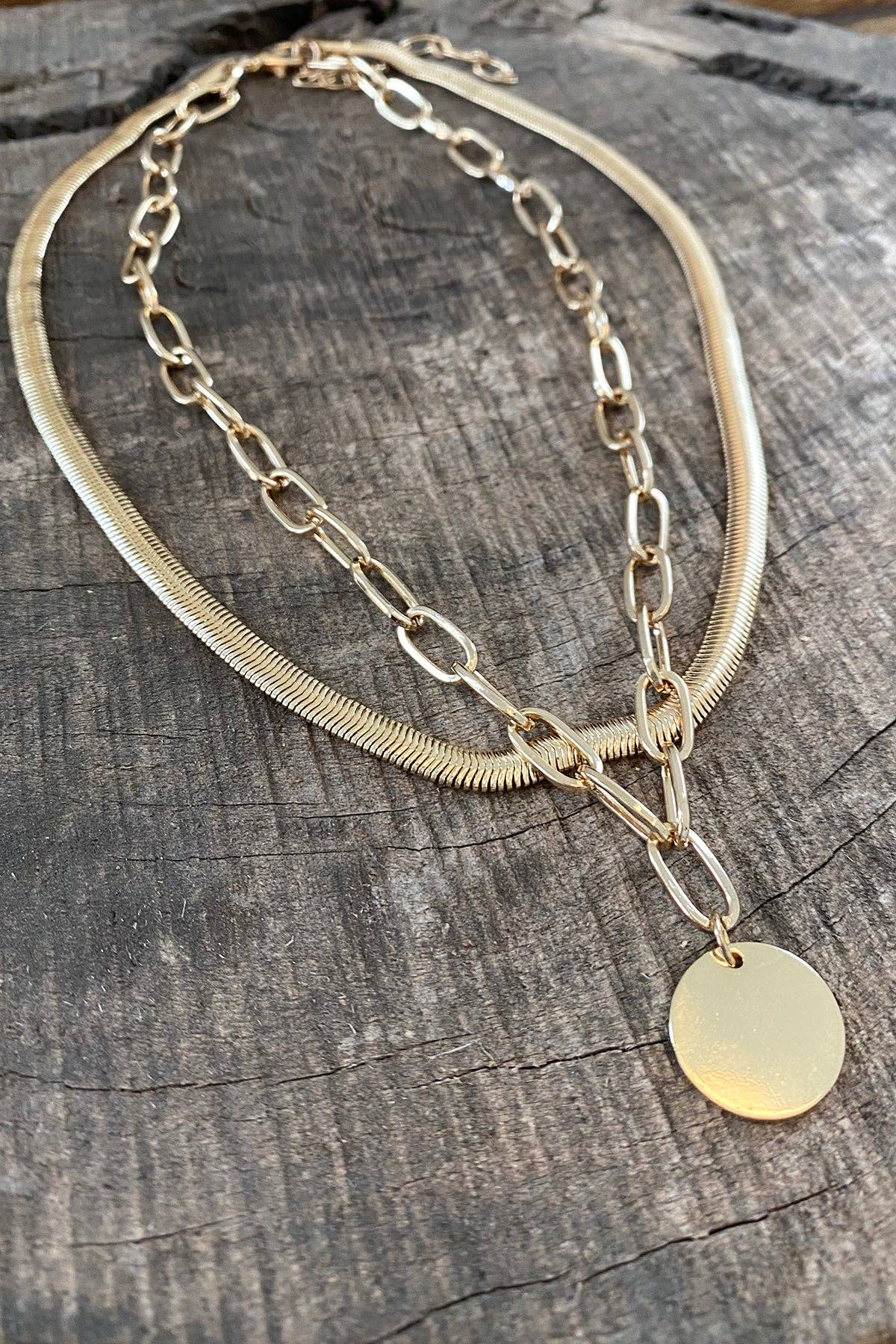 Layered gold tone necklace with coin pendant