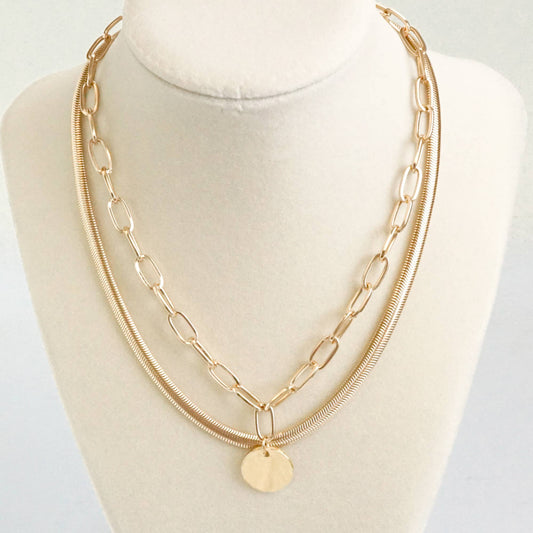 Layered gold tone necklace with coin pendant
