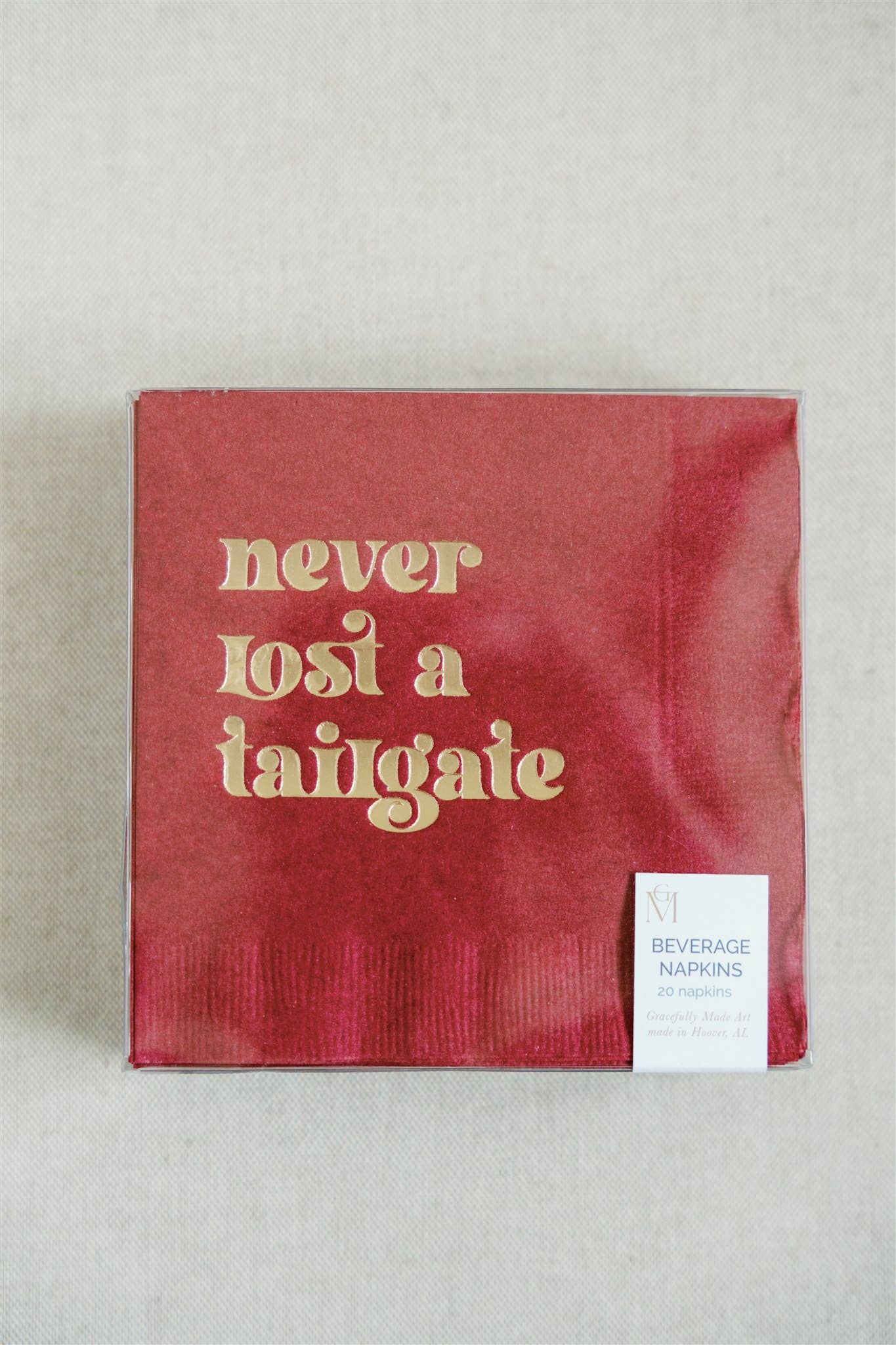 "Never Lost a Tailgate" gold foil + red napkin pack