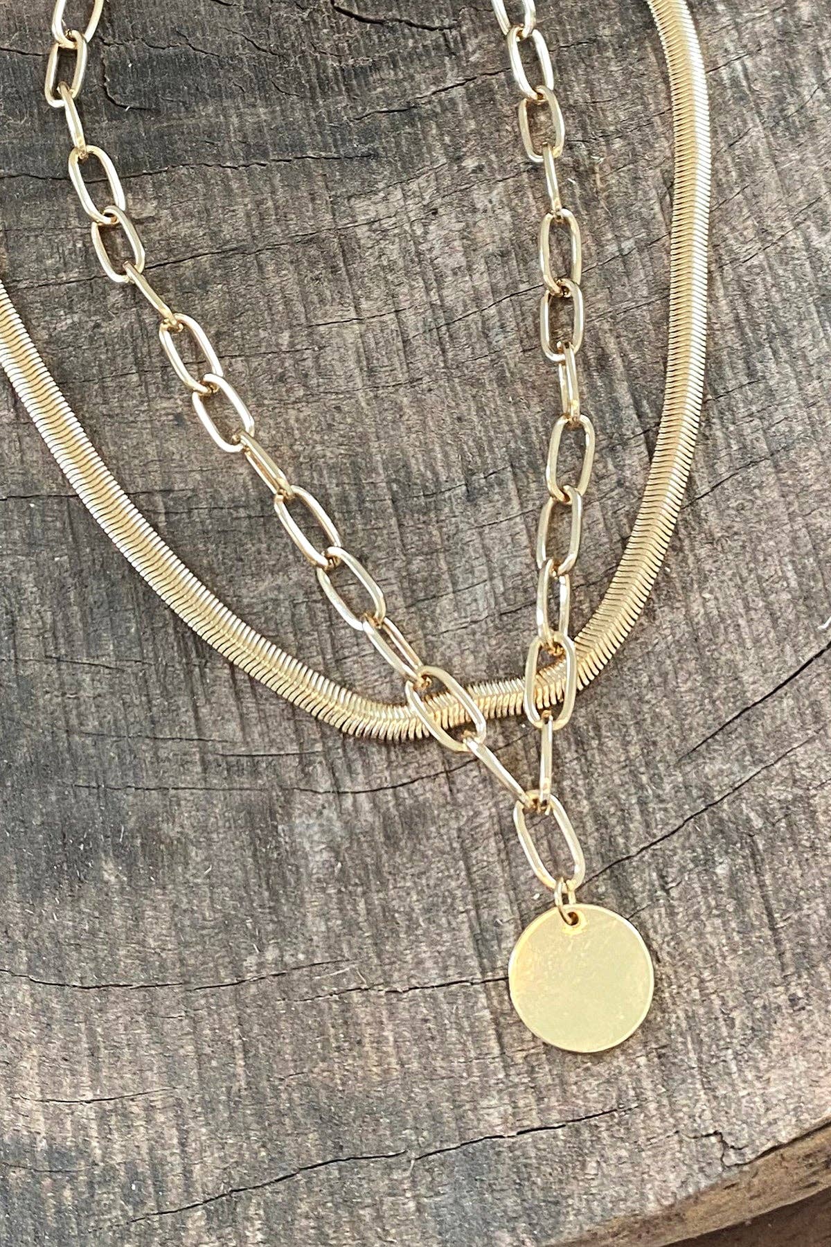 Layered gold tone necklace with coin pendant