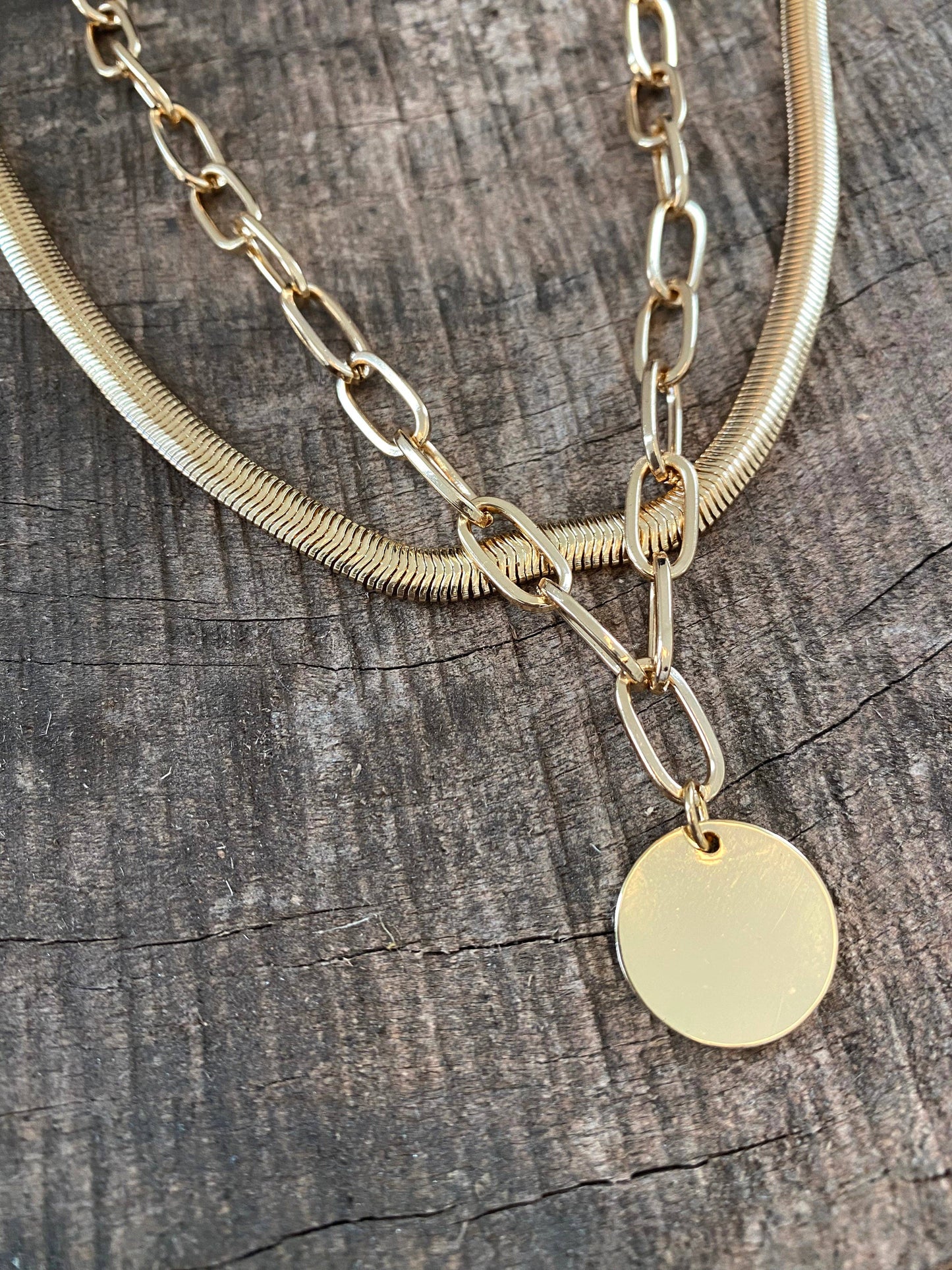 Layered gold tone necklace with coin pendant