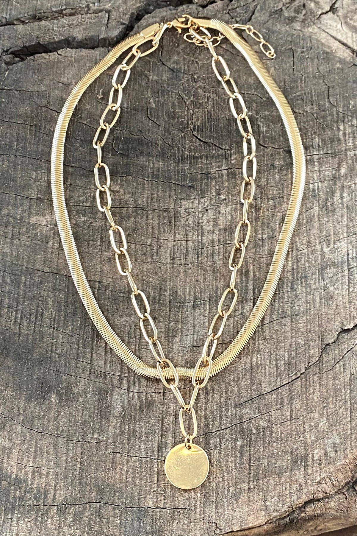 Layered gold tone necklace with coin pendant