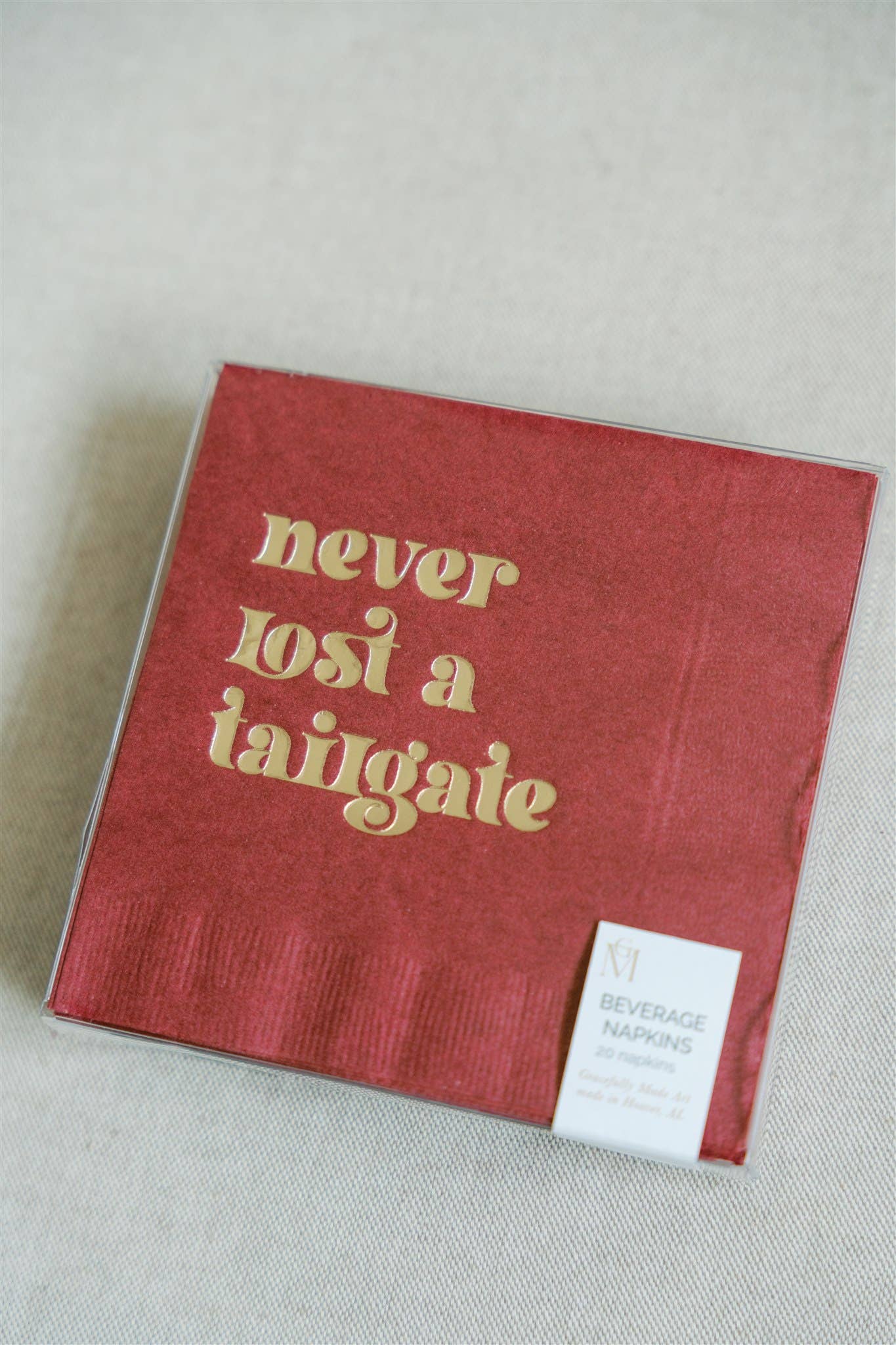 "Never Lost a Tailgate" gold foil + red napkin pack